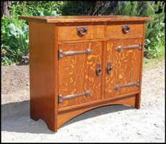 Gustav Stickley inspired custom two door cabinet  with two drawers and hammered copper strap hinges.